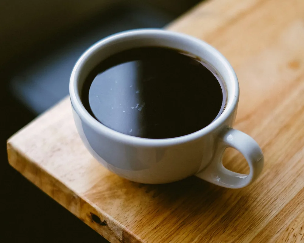 Pour-over coffee dripping into a glass carafe