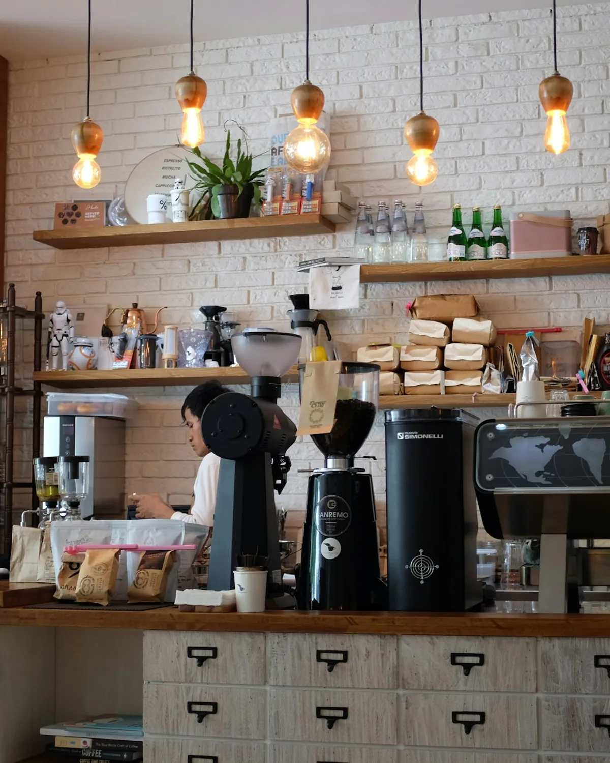 Warm interior of Crave Coffee House — wooden tables, plants, golden afternoon light
